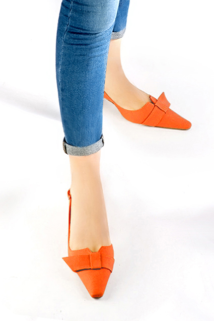 Women's clementine orange elegant slingback heels, with a bow on the front. Tapered toe. Medium spool heels - Worn view